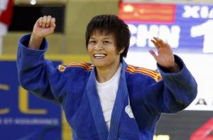 China's Xian Dongmei celebrates after defeating Algeria's Soraya Haddad