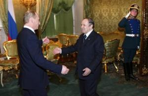 Russian President Vladimir Putin, left, greets Algerian President Abdelaziz