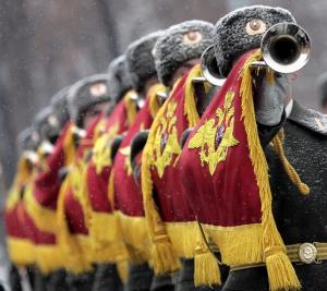 Trumpeters of Russian honor guards march during a wreath-laying