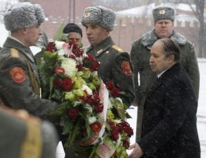 Algeria's President Abdelaziz Bouteflika (front R) attends a wreath-laying