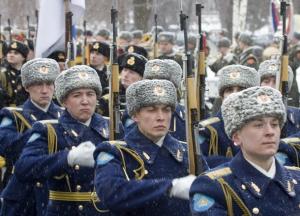 Honour guards march during a wreath laying ceremony attended