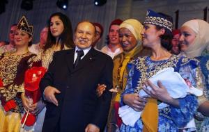 Algeria's President Abdelaziz Bouteflika jokes as his poses with