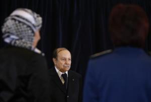 Algeria's President Abdelaziz Bouteflika (C) listens to the national