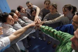 The women's Olympic volleyball team cheer after a training
