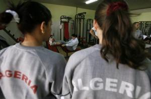 Volleyball players from the women's Olympic team watch their