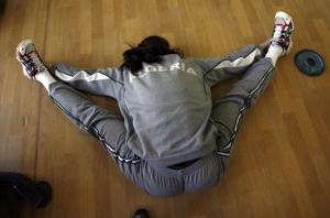 Women's Olympic volleyball player Yamina Azmi stretches during a