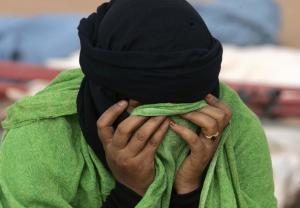 A Saharawi woman hides her face at Dakhla's refugee