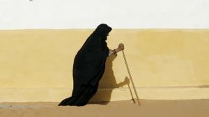 A Sahrawi woman walks with a stick at Dakhla's