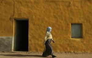 A Sahrawi woman walks past Carlo Giuliani school at