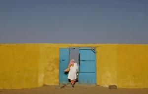 A Sahrawi woman walks through the door of Carlo