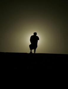 A man watches the sunset at the Sahara desert