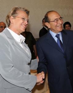 Algerian Interior Minister Noureddine Yazid Zerhouni (R) shakes hand