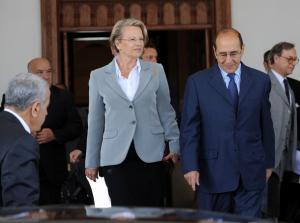 Algerian Interior Minister Noureddine Yazid Zerhouni (R) escorts his