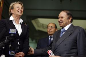 Algeria's President Abdelaziz Bouteflika (R) stands with French Interior
