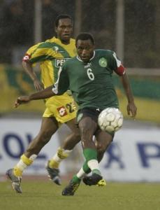 Ahmadou Ncomna of Cameroon's Coton Sport (front) fights for