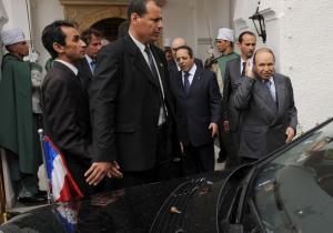 Algerian President Abdelazziz Bouteflika (R) says goodbye to the