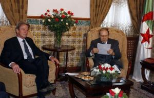 Algeria's President Abdelaziz Bouteflika (R) reads a letter from