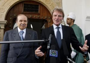 Algeria's President Abdelaziz Bouteflika (L) listens to France's Foreign