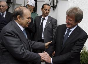 Algeria's President Abdelaziz Bouteflika (L) greets France's Foreign Minister
