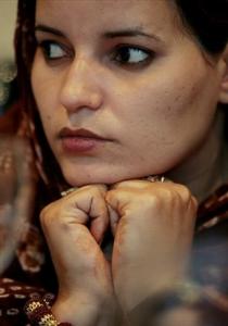 Naha Al Salek Sidi listens during a press interview