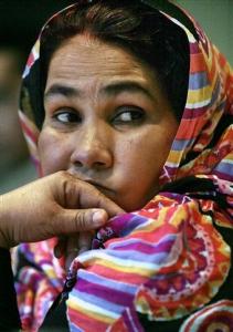 Naba Deddah El Meki listens during a press interview