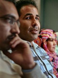 Brahim Al Selem, center, speaks during a press interview