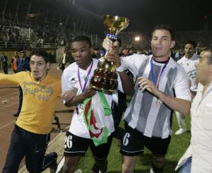 Jeefery Serey (C) and Benchaira Kamel (R) of Algeria's