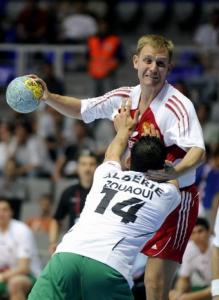Vasily Ivanov  of Russia (with ball) is challenged