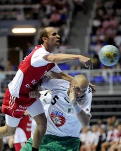 Timur Dibirov (L) of Russia tries to score over