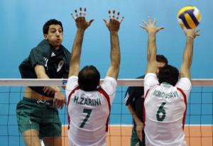 Algeria's Chikhi Mohamed (L) spikes the ball past Iran's