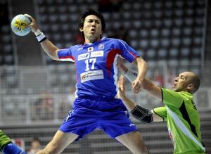 Masayuki Furuie (L) of Japan tries to score over