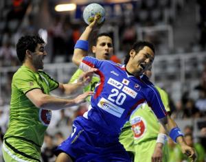 Masakatsu Izuma (with ball) of Japan tries to score