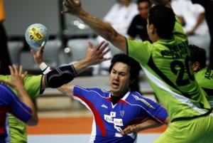 Kyosuke Tomita (C) of Japan shoots past Ali Sid