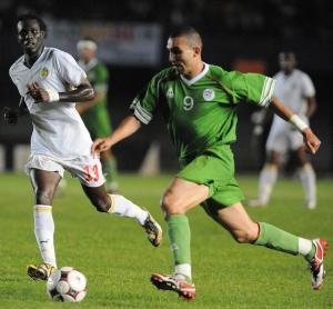Senegalese footballer Pape Malick Ba (L) vies with Algeria's