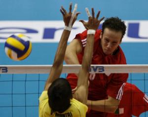 Algeria's Oumessad Mohamed Amine (R) spikes the ball past