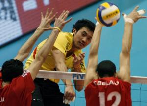 Thailand's Wanchai Tabwises (C) spikes the ball past Algeria's