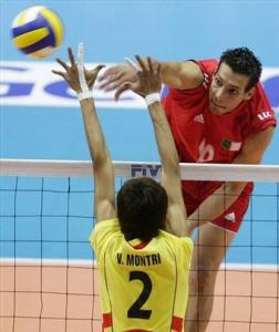 Algeria's Mahdjoubi Toufik spikes the ball against Thailand's Montri