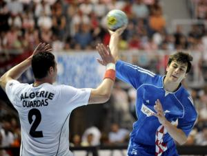 Domagoj Duvnak of Croatia (blue) tries to score over