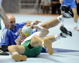 Davor Dominikovic of Croatia (L) fights for the ball
