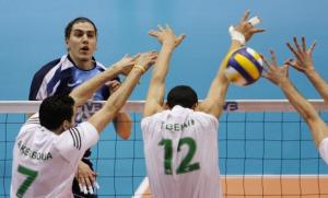 Argentina's Lucas Chavez (top) spikes the ball past Algeria's