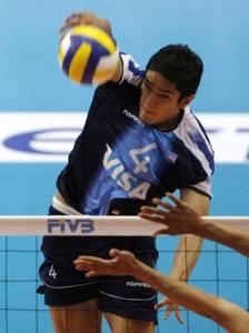 Argentina's Lucas Ocampo (top) spikes the ball past Algeria's