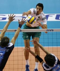 Algeria's Chikhi Mohamed (top) spikes the ball past Argentina's