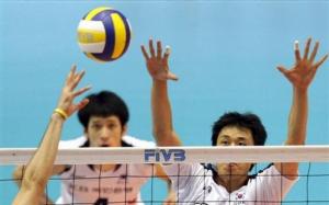 South Korea's Choi Tae-woong, right, blocks against Algeria during