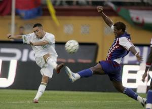 Algeria's Karim Ziani (L) kicks the ball past Liberia's