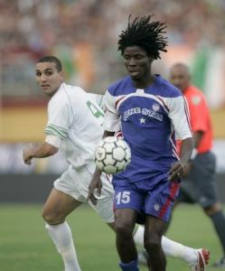 Liberia's Dixw Jimmy (R) fights for the ball with