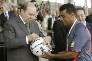Algerian President Abdelaziz Bouteflika signs a ball held by