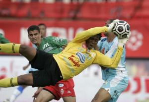 JSM Bejaia's goalkeeper Bilal Njeukam (front) saves a shot