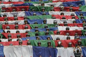 Algerian rescue workers hold flags of both teams during