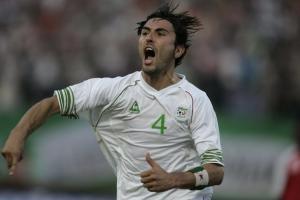 Algeria's Antar Yahia celebrates after scoring against Gambia during
