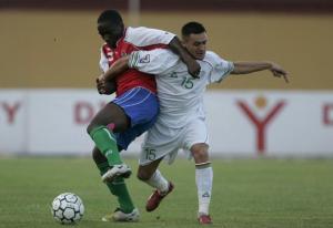 Gambia's Saikou Kutabi (L) fights for the ball with